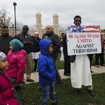 "Muslims stand against terrorism with red, white and blue signs"